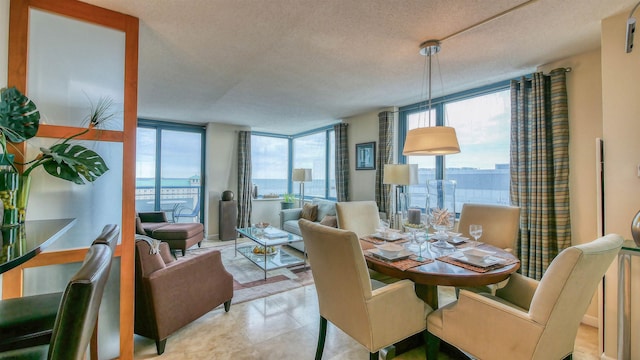 dining space featuring a wall of windows and a textured ceiling