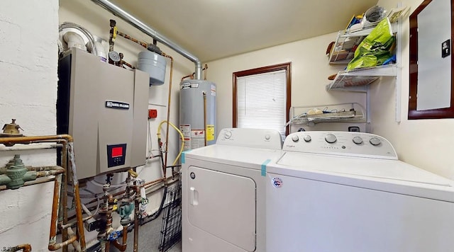 clothes washing area featuring separate washer and dryer and water heater