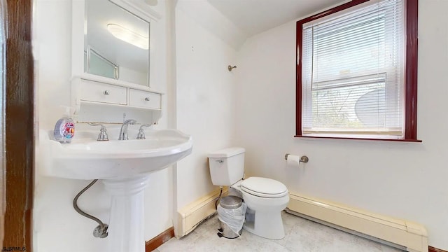 bathroom featuring plenty of natural light, toilet, and a baseboard radiator