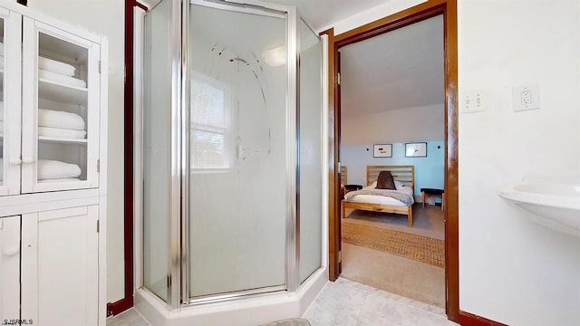 bathroom with tile patterned flooring and walk in shower