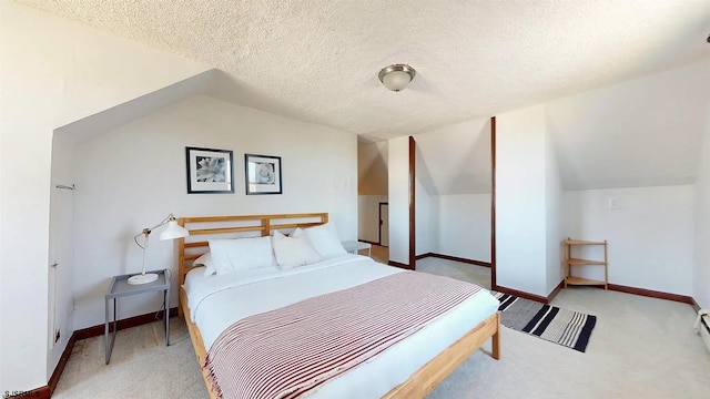 carpeted bedroom with a textured ceiling, a baseboard radiator, and vaulted ceiling