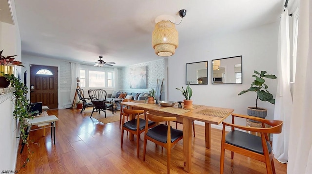 dining area featuring wood-type flooring and ceiling fan