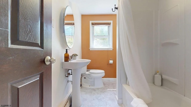 bathroom featuring tile patterned floors, toilet, and shower / bathtub combination with curtain