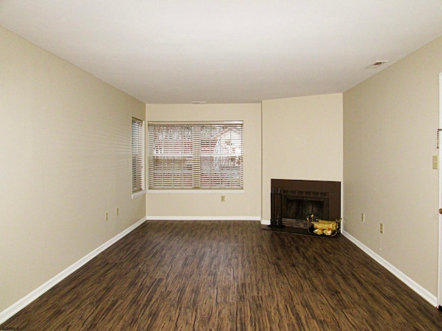 unfurnished living room with dark hardwood / wood-style floors