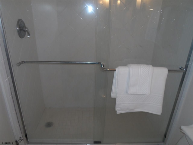 bathroom with a shower with shower door