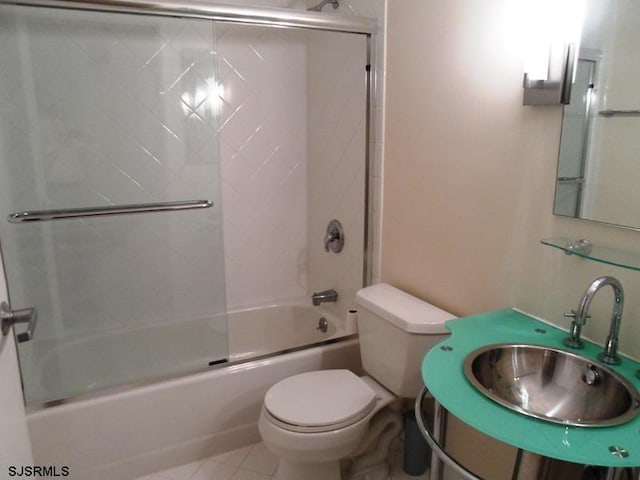 full bathroom featuring tile patterned floors, sink, toilet, and combined bath / shower with glass door