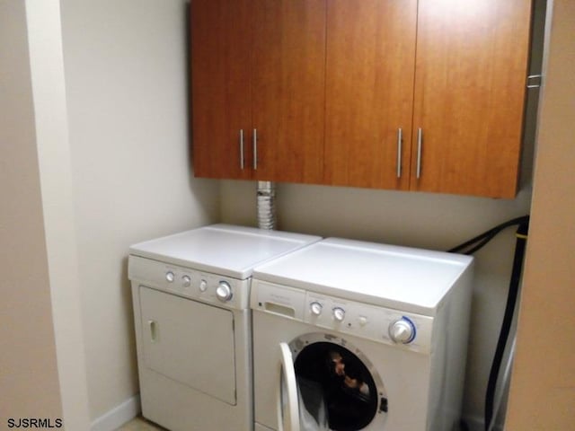 laundry area featuring cabinets and washer and dryer