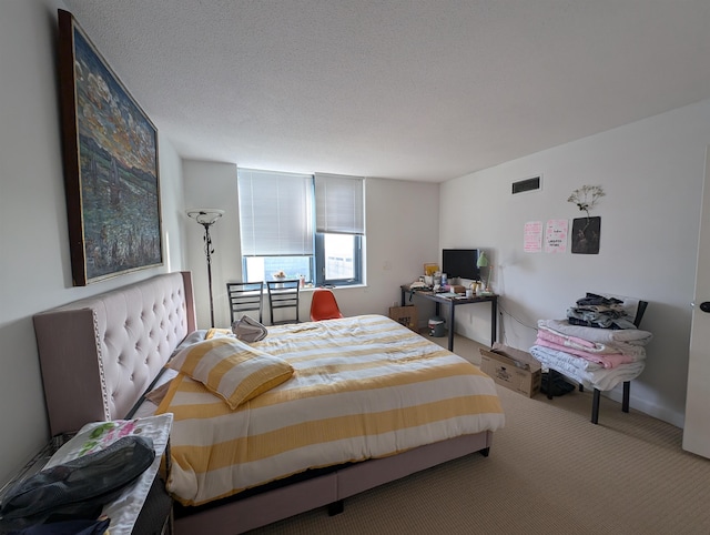 bedroom with carpet and a textured ceiling