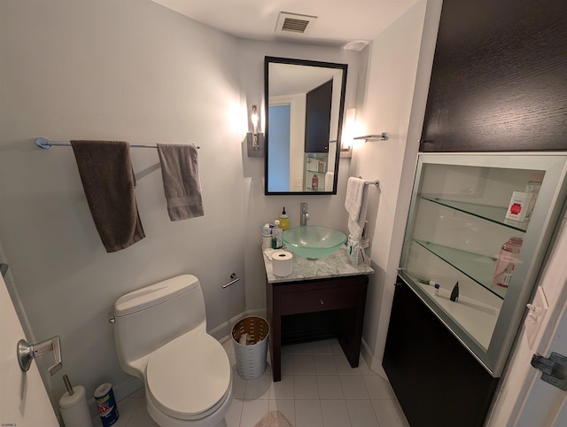 bathroom featuring tile patterned flooring, vanity, and toilet