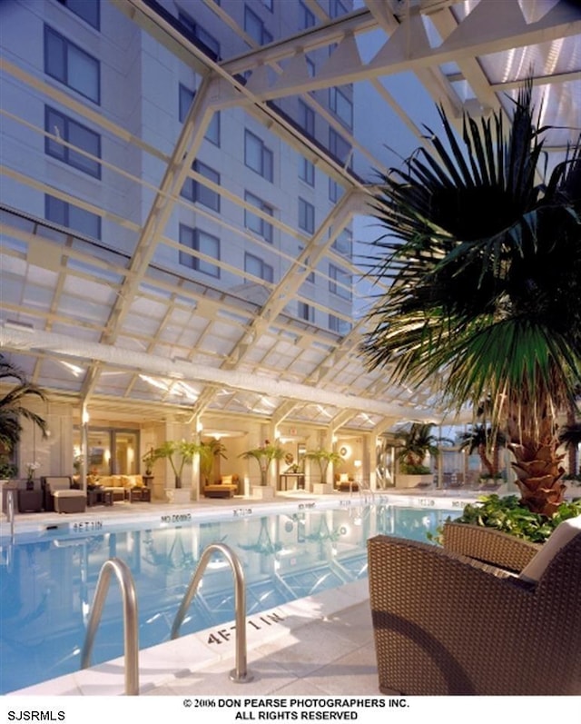 view of swimming pool with outdoor lounge area, ceiling fan, and a patio area