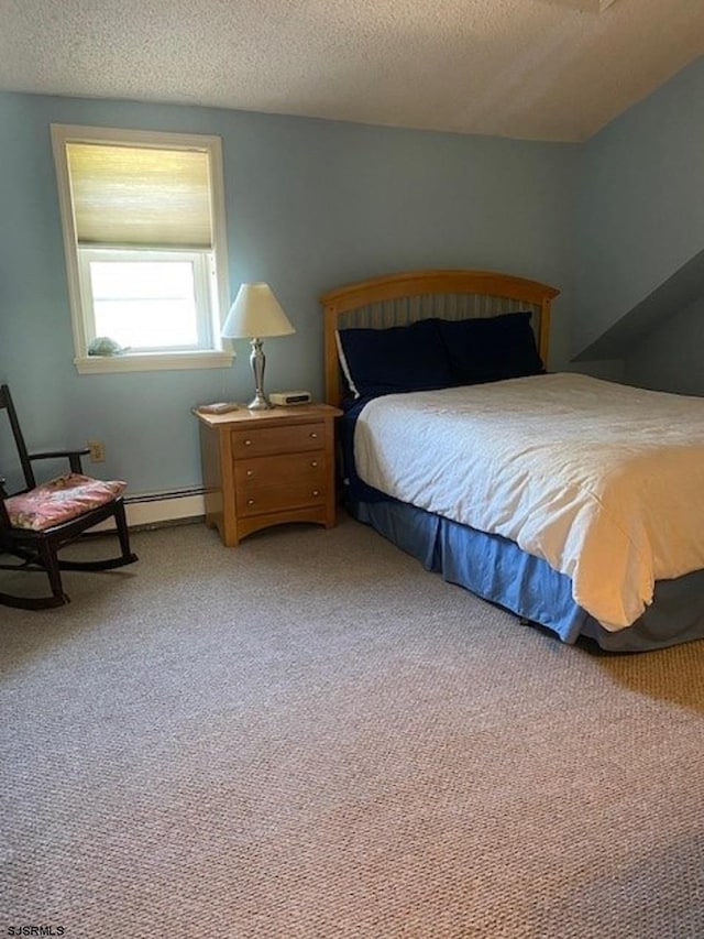 bedroom with a textured ceiling and light colored carpet