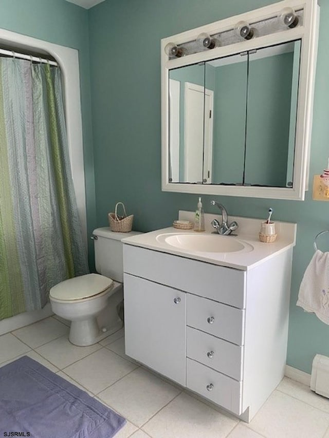 bathroom with tile patterned flooring, vanity, and toilet