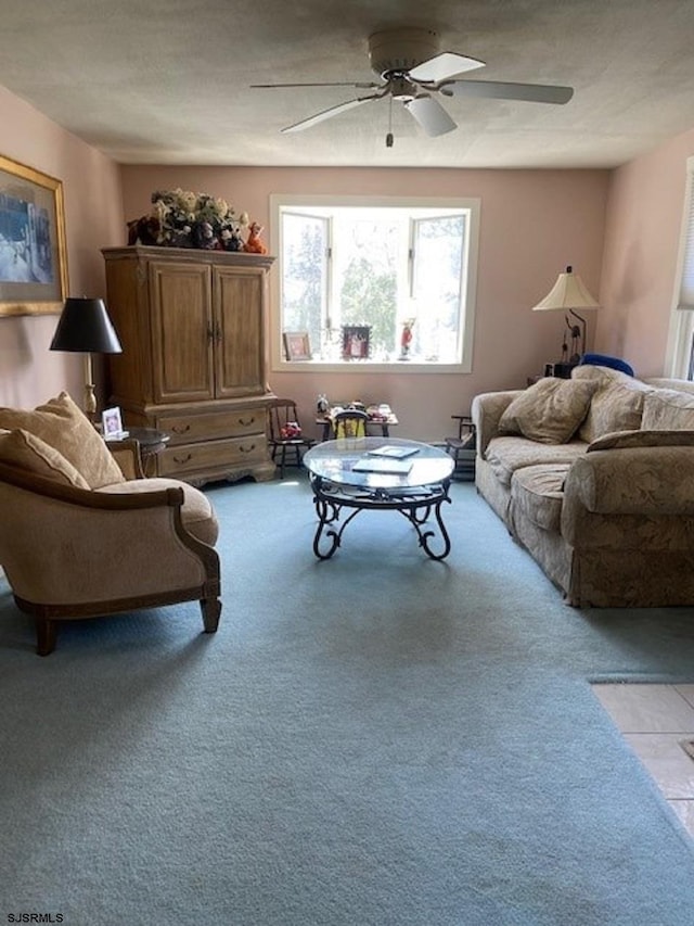 living room with ceiling fan and light colored carpet