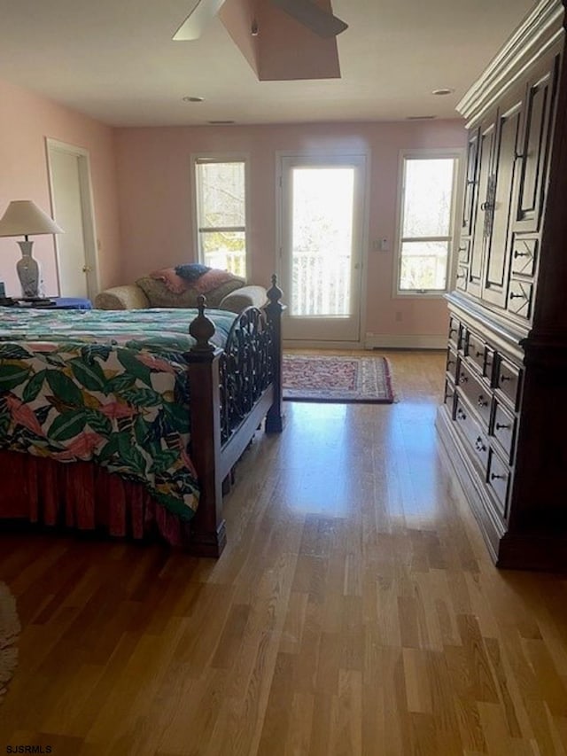 bedroom with ceiling fan and light hardwood / wood-style floors