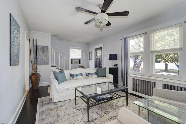 living room with ceiling fan, radiator heating unit, crown molding, cooling unit, and wood-type flooring