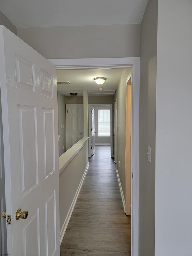 hall with hardwood / wood-style floors