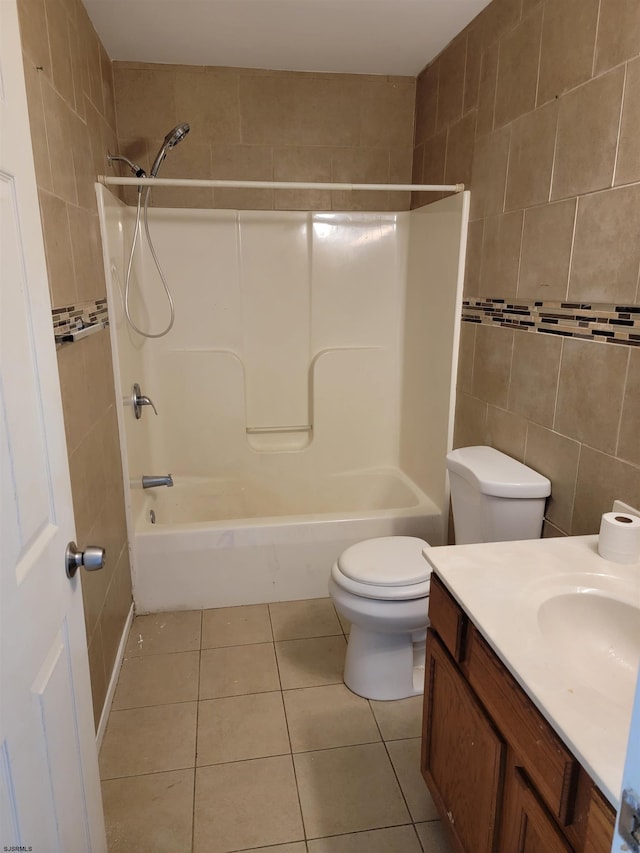 full bathroom featuring shower / bathing tub combination, vanity, tile patterned flooring, toilet, and tile walls