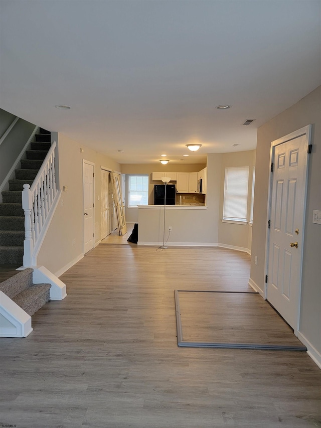 unfurnished living room with light hardwood / wood-style flooring