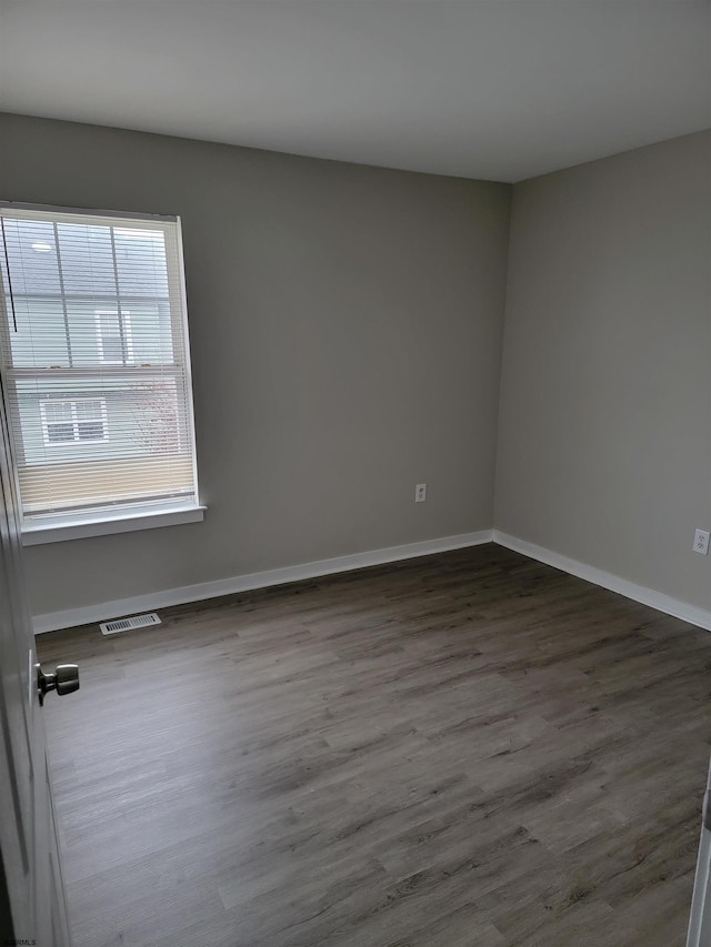 spare room with dark hardwood / wood-style floors