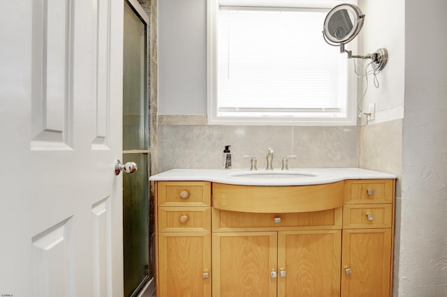 bathroom featuring vanity and backsplash