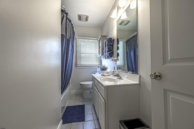 full bathroom featuring tile patterned floors, shower / bath combo with shower curtain, vanity, and toilet