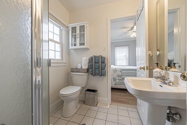 bathroom featuring tile patterned floors, ceiling fan, a healthy amount of sunlight, and ornamental molding