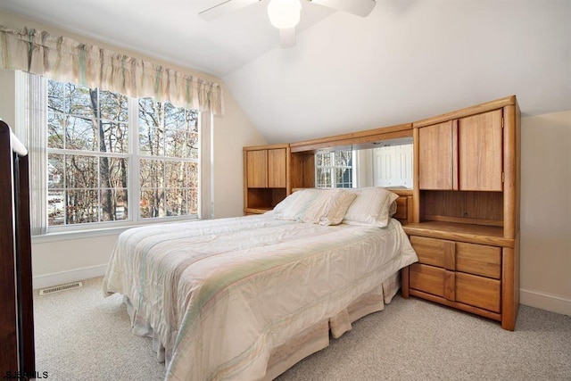 carpeted bedroom with ceiling fan, lofted ceiling, and multiple windows