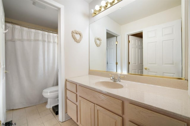 bathroom with tile patterned flooring, vanity, and toilet