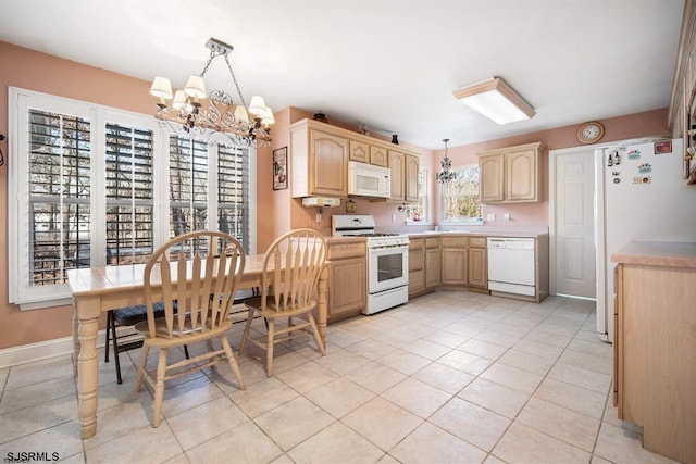 kitchen featuring a chandelier, decorative light fixtures, white appliances, light brown cabinetry, and light tile patterned floors