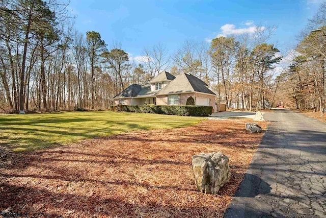 view of property exterior featuring a garage and a yard