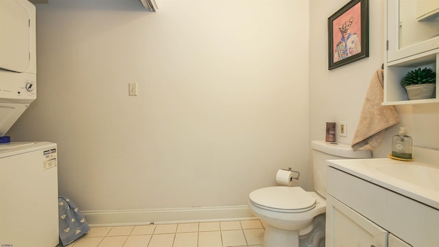 bathroom with tile patterned floors, stacked washer and dryer, vanity, and toilet