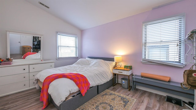 bedroom featuring wood-type flooring and lofted ceiling