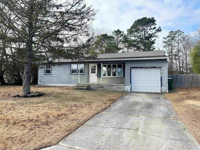 single story home with a front yard and a garage