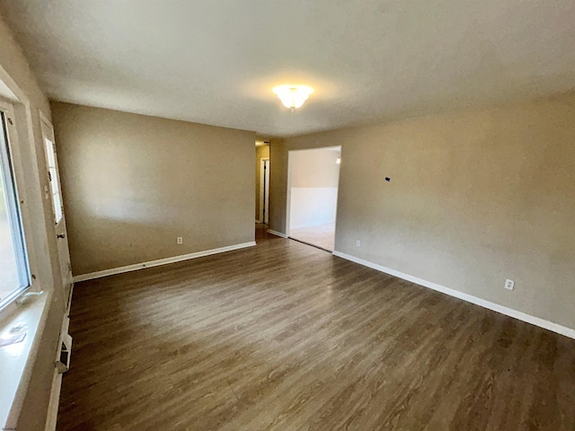 empty room with dark hardwood / wood-style floors