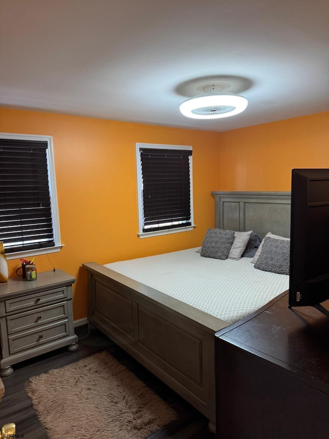 bedroom with dark wood-type flooring