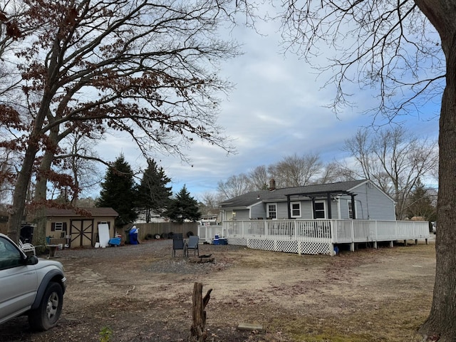 exterior space with a storage shed and a wooden deck