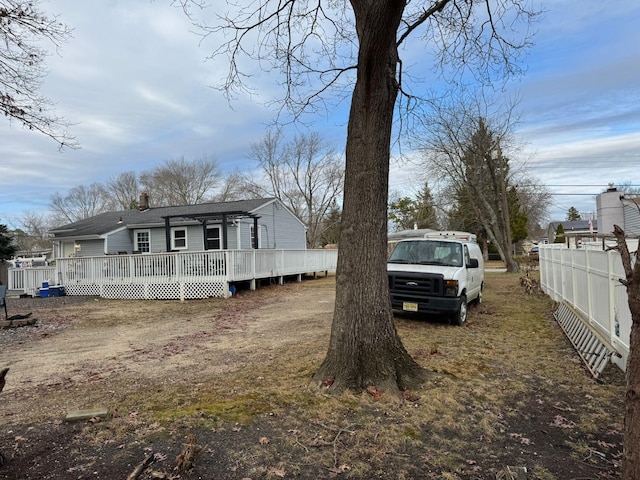 view of property exterior with a wooden deck