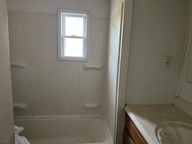 bathroom featuring vanity and a bath