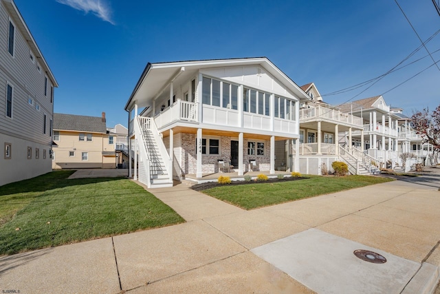 view of front of home with a porch and a front lawn