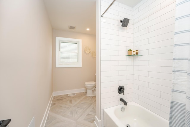 bathroom with shower / tub combo and toilet