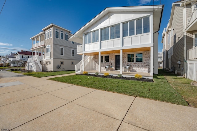 view of front of property with a porch and a front yard