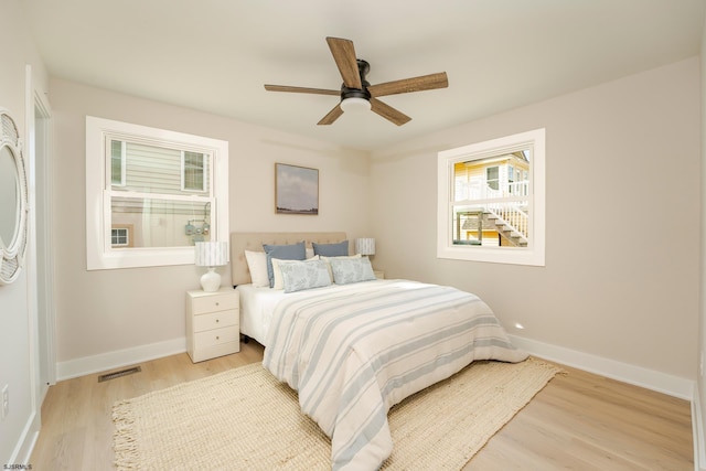 bedroom with light wood-type flooring and ceiling fan