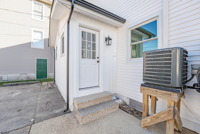 view of exterior entry with central air condition unit