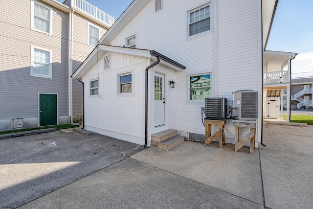 rear view of property featuring central AC