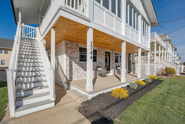 back of house featuring a porch