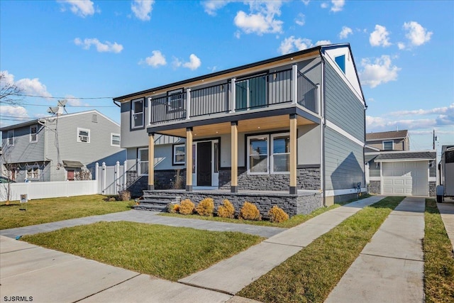 view of front facade with a balcony, covered porch, a front yard, and a garage