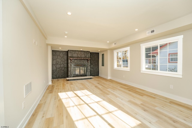 unfurnished living room with light hardwood / wood-style floors and a fireplace