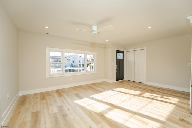 empty room featuring ceiling fan and light hardwood / wood-style floors