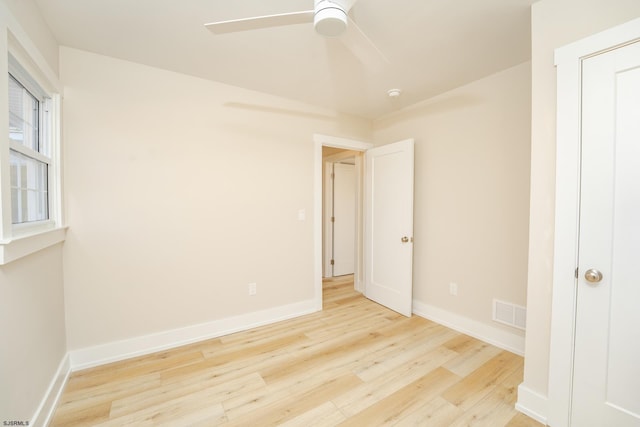 unfurnished bedroom with ceiling fan and light hardwood / wood-style flooring