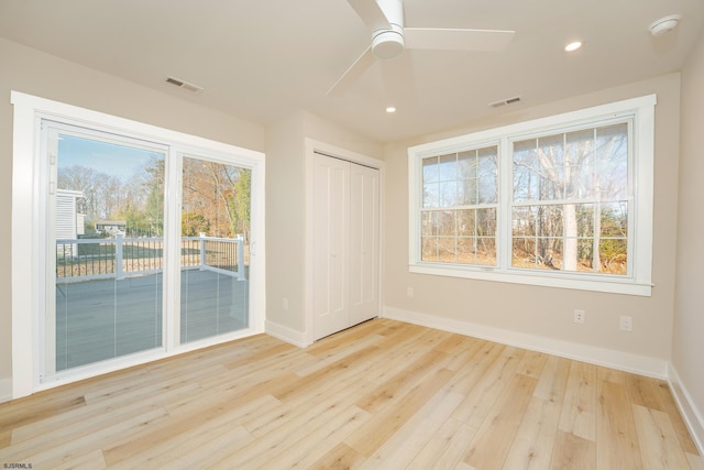 empty room with ceiling fan and light wood-type flooring